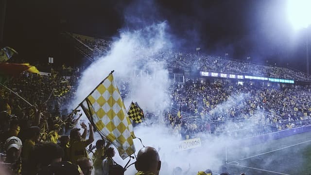Football stadium under floodlights