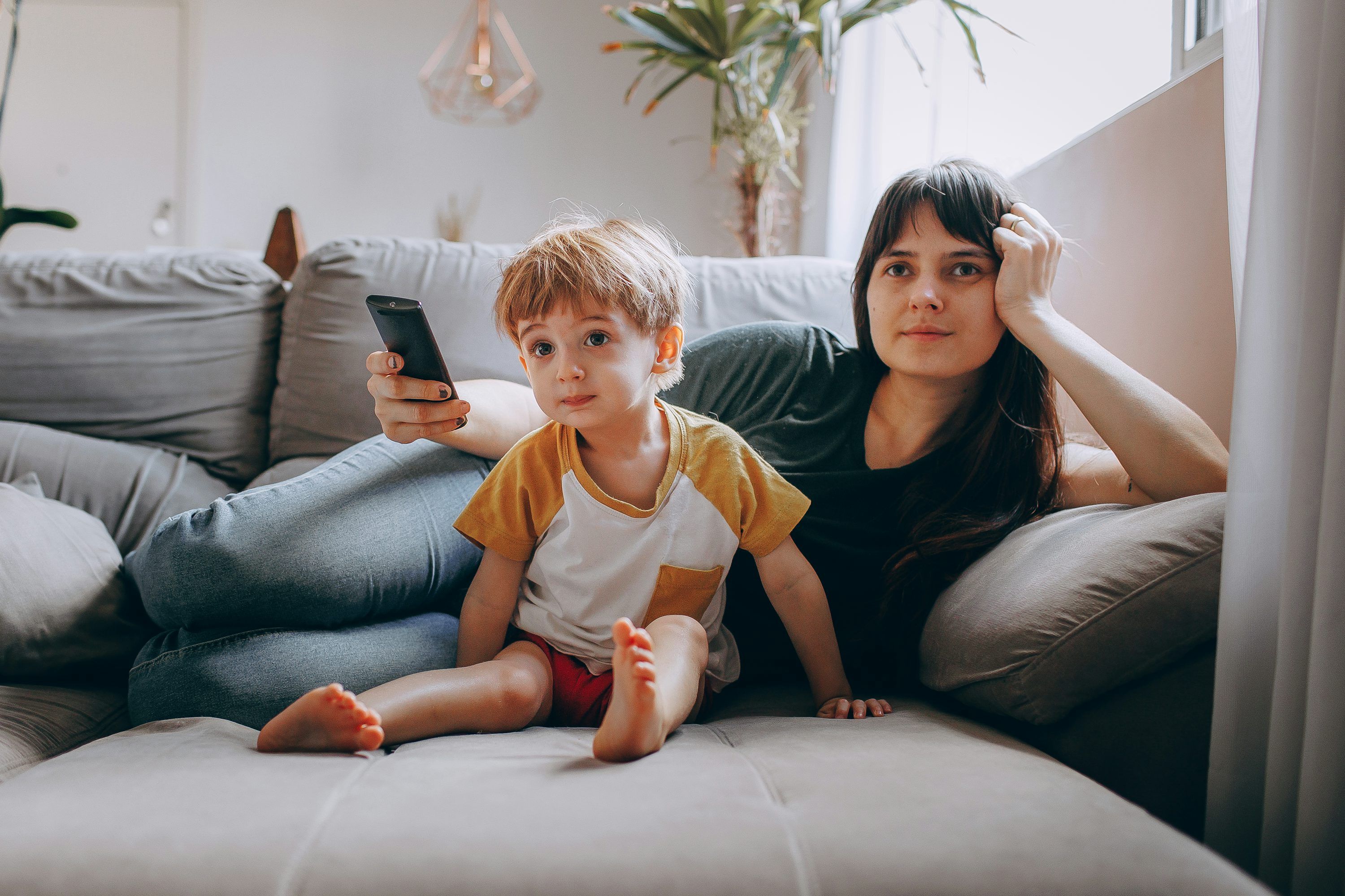 Family deciding between annual and lifetime IPTV subscription plans on smart TV