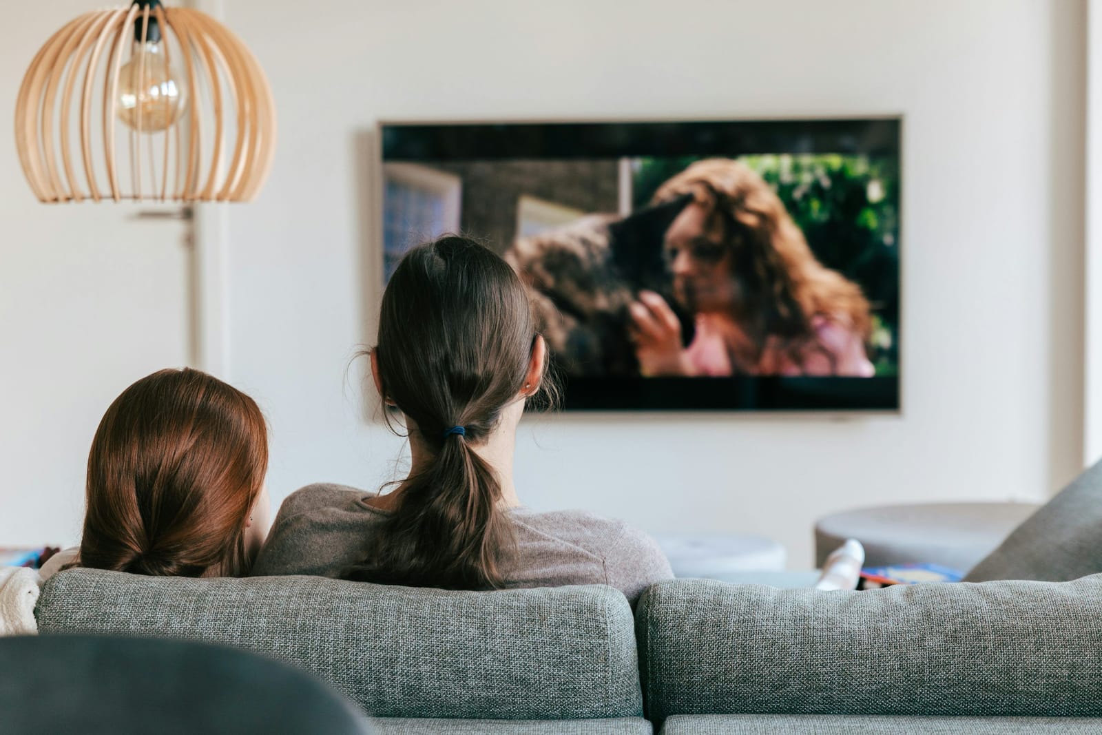 Family streaming Nordic IPTV channels on a large smart TV in a living room